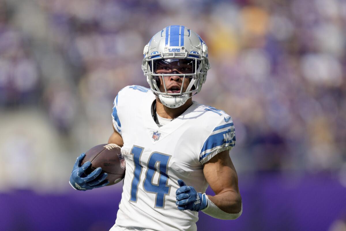 Detroit Lions wide receiver Amon-Ra St. Brown carries the ball.