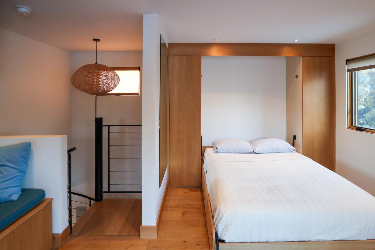 A Murphy bed open in a room in an ADU.