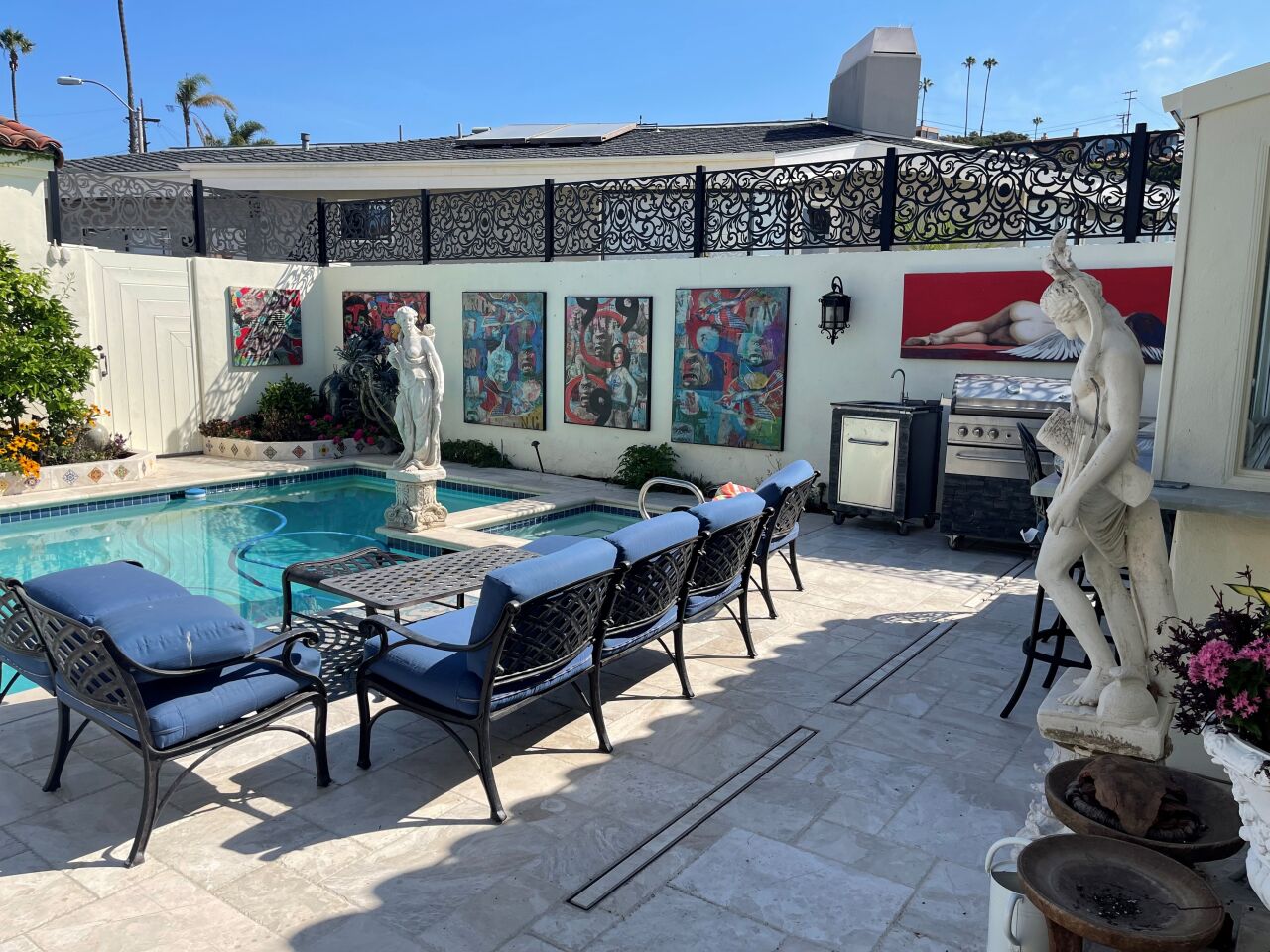The Spanish-style courtyard at artist Dottie Stanley's La Jolla home features large artworks on the walls and multiple statues of mythical figures.
