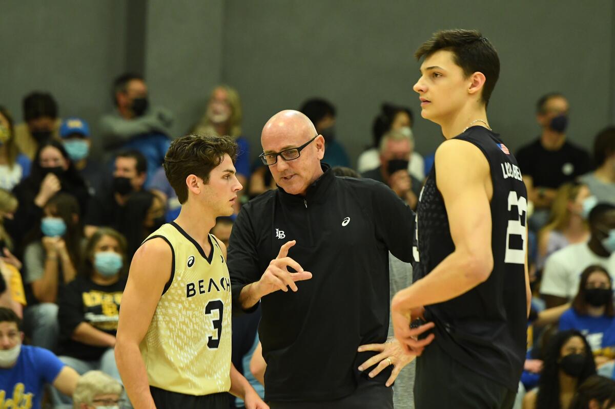 Long Beach State coach Alan Knipe, center, speaks with libero Mason Briggs, left, and outside hitter Alex Nikolov.