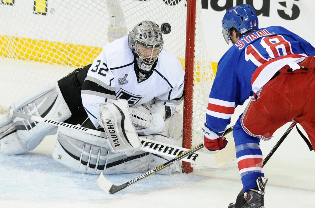 Kings goalie Jonathan Quick makes a save on a shot by New York Rangers defenseman Marc Staal during the first period of Game 4 of the Stanley Cup Final.