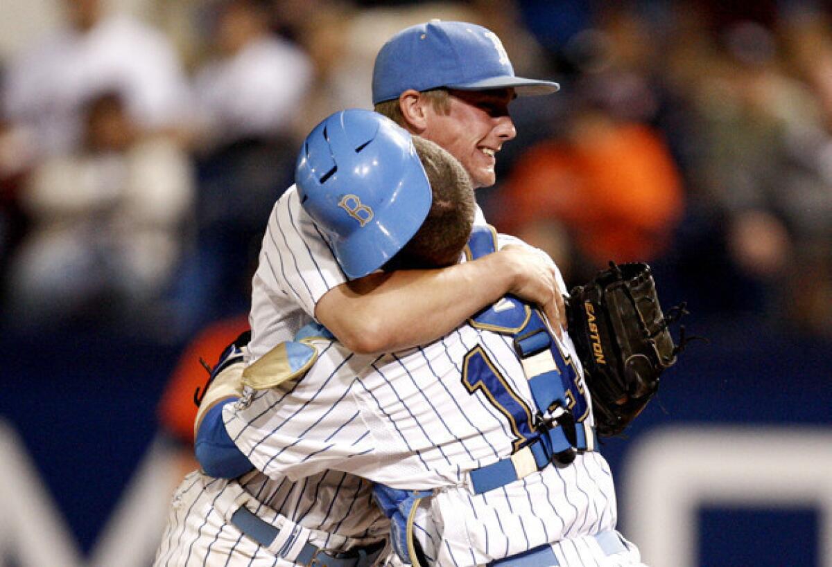 UCLA closing pitcher David Berg, left, hugs catcher Shane Zeile after the final out against Cal State Fullerton in the super-regionals.