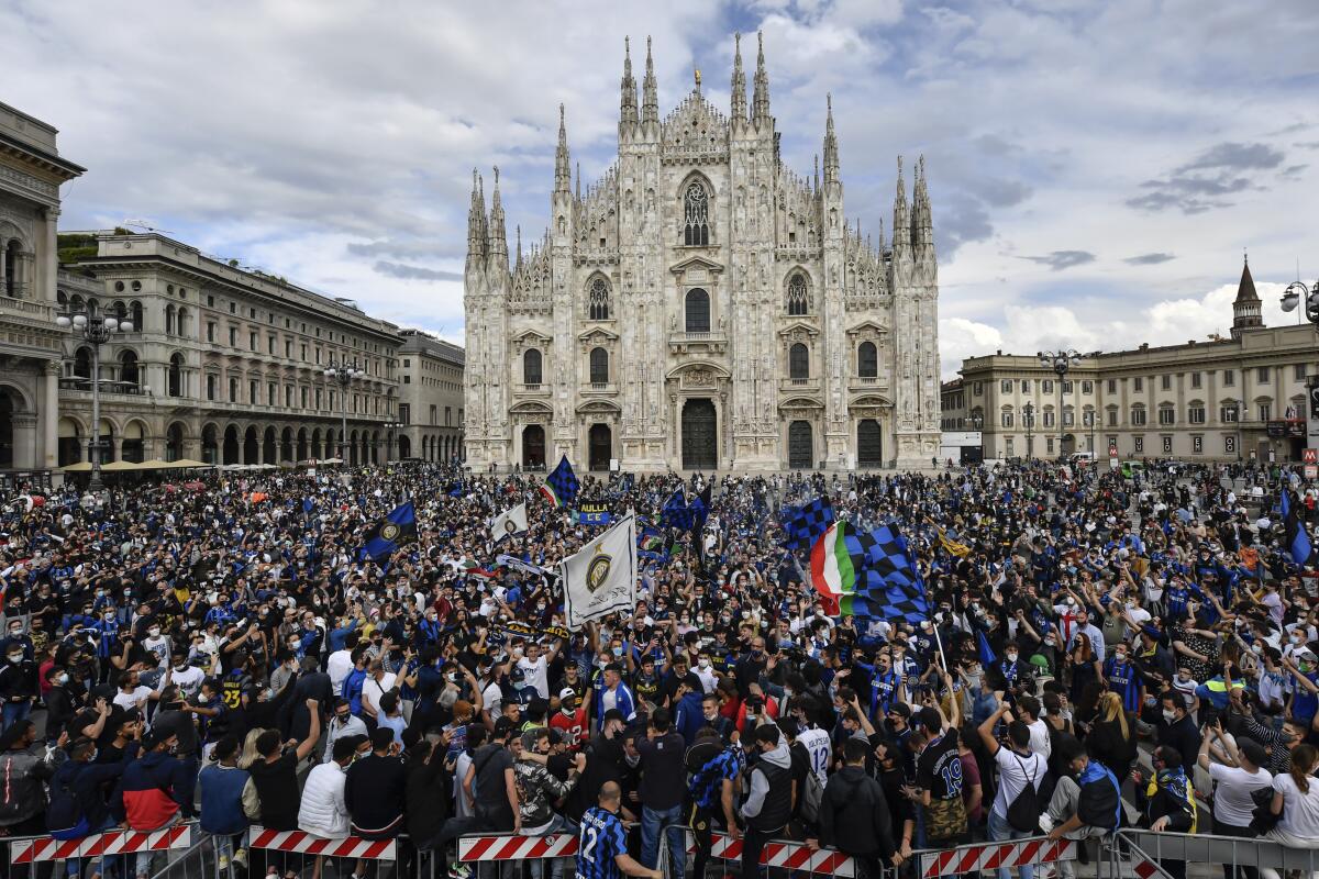 Inter Milan fans crowd Piazza Duomo square in front of the gothic cathedral after Inter Milan won its first Serie A title in more than a decade after second-placed Atalanta drew 1-1 at Sassuolo, in Milan, Italy, Sunday, May 2, 2021. Atalanta needed to win to avoid Inter mathematically clinching the title with four matches remaining. It was Inter’s first trophy since 2011 and the first Serie A title since 2010. (Claudio Furlan/LaPresse via AP)