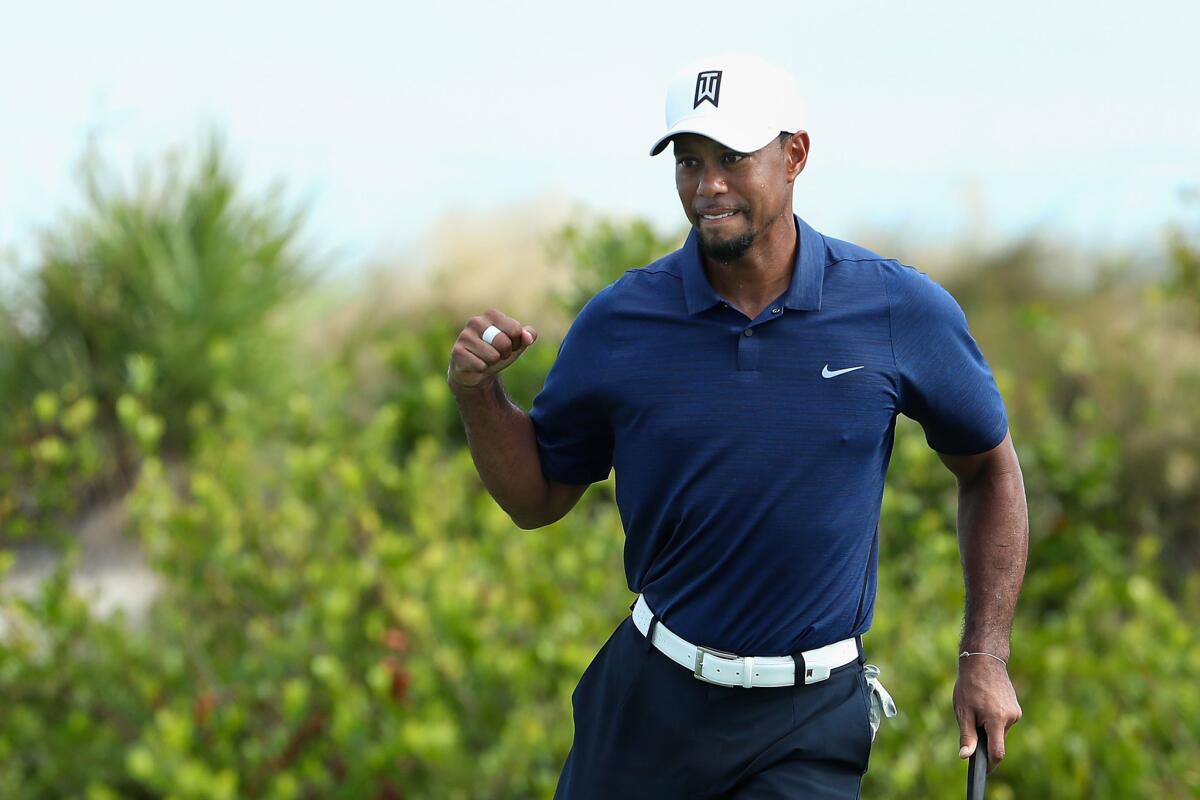 Tiger Woods celebrates after a putt on the 16th green Friday at the Hero World Challenge.