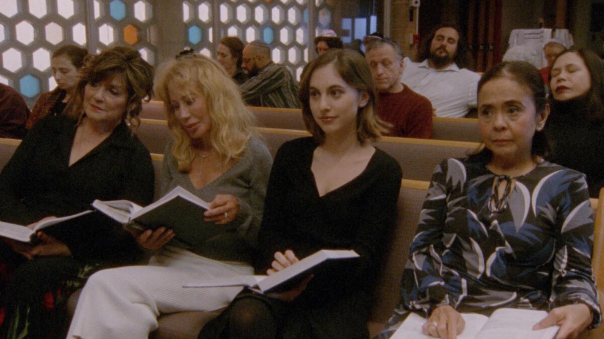 Four women sit in a synagogue.