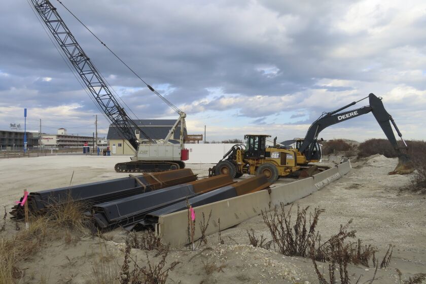Construction equipment and material sits on the beach in North Wildwood, N.J. on Jan. 5, 2023. On Feb. 1, 2023, a judge denied the city permission to build a bulkhead to protect against erosion, but allowed it to move forward with a $21 million lawsuit seeking damages from the state to recoup the cost of sand the city trucked in at its own expense in the absence of a state and federal beach replenishment project. (AP Photo/Wayne Parry)