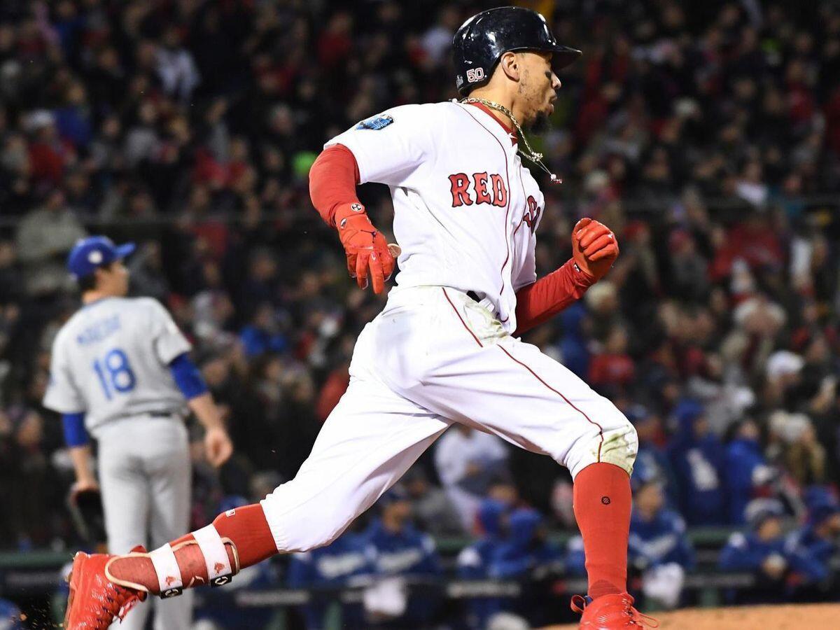 Boston's Mookie Betts scores a run in the fifth inning of Game 2 of the World Series against the Dodgers at Fenway Park.