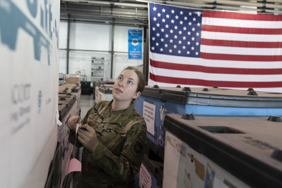 U.S. Air Force Airman Megan Konsmo, from Tacoma, Wash., checks pallets of equipment ultimately bound for Ukraine in the Super Port of the 436th Aerial Port Squadron, Friday, April 29, 2022, at Dover Air Force Base, Del. President Joe Biden asked Congress on Thursday for $33 billion to bolster Ukraine's fight against Russia, signaling a burgeoning and long-haul American commitment. (AP Photo/Alex Brandon)