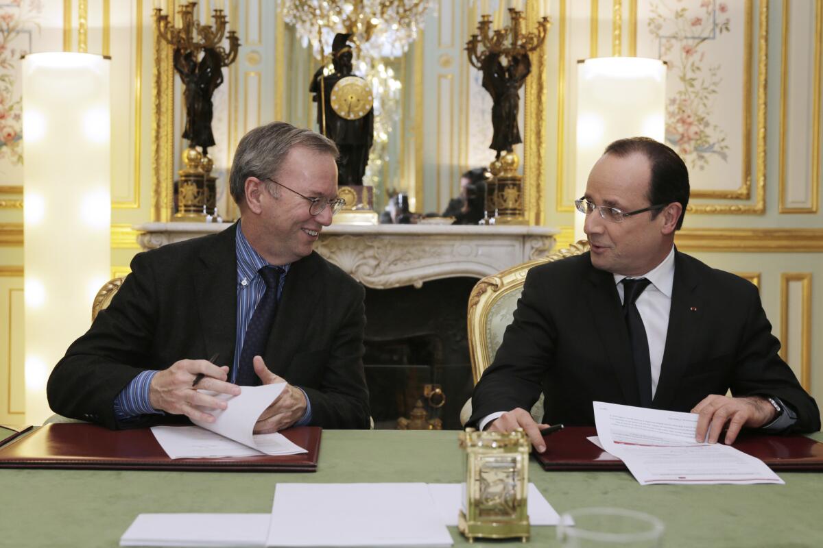 French President Francois Hollande, right, meets with Google Executive Chairman Eric Schmidt at the Elysee Palace in Paris.