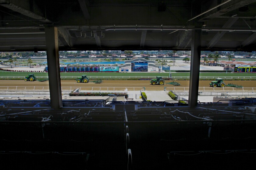 Tractors resurface the track an hour before the first race scheduled Friday at Del Mar Thoroughbred Club.