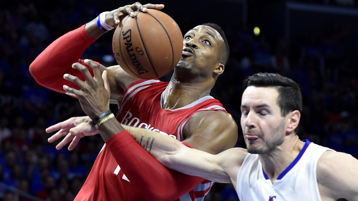 Clippers guard J.J. Redick fouls Rockets center Dwight Howard on a breakaway layup in the fourth quarter of Game 6 on Thursday night at Staples Center.