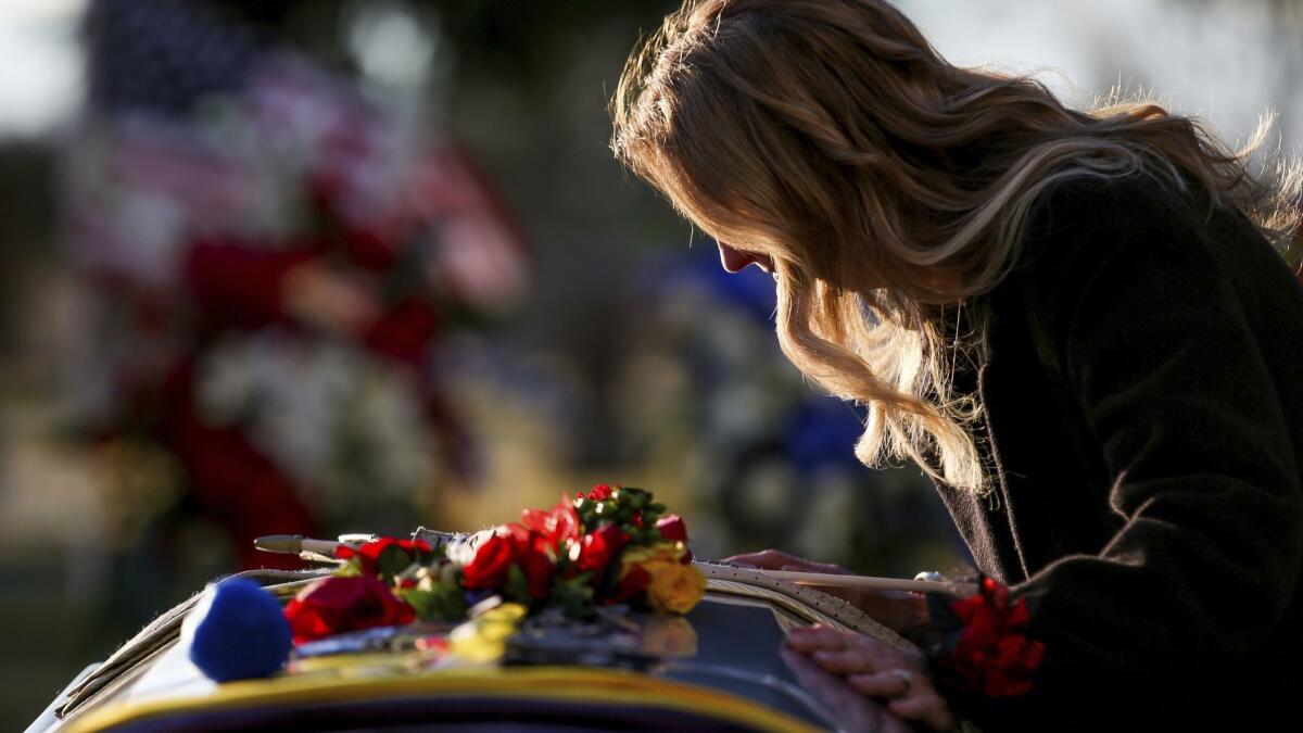 Tammy Taylor, mother of Maj. Brent Taylor, 39, takes a moment beside his casket at the end of his interment at the Ben Lomond Cemetery in North Ogden, Utah, on Saturday.