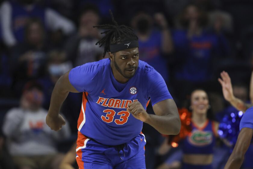 Florida center Jason Jitoboh (33) runs up court after making a shot against Alabama during the first half of an NCAA college basketball game, Jan. 5, 2022, in Gainesville, Fla. Jitoboh took a finger to his left eye at Tennessee last January and spent the better part of a year trying to get right. He’s had four surgeries already and might have a fifth following the season. He faces the second-ranked Volunteers for the first time since his injury when Florida hosts Tennessee on Wednesday. (AP Photo/Matt Stamey)
