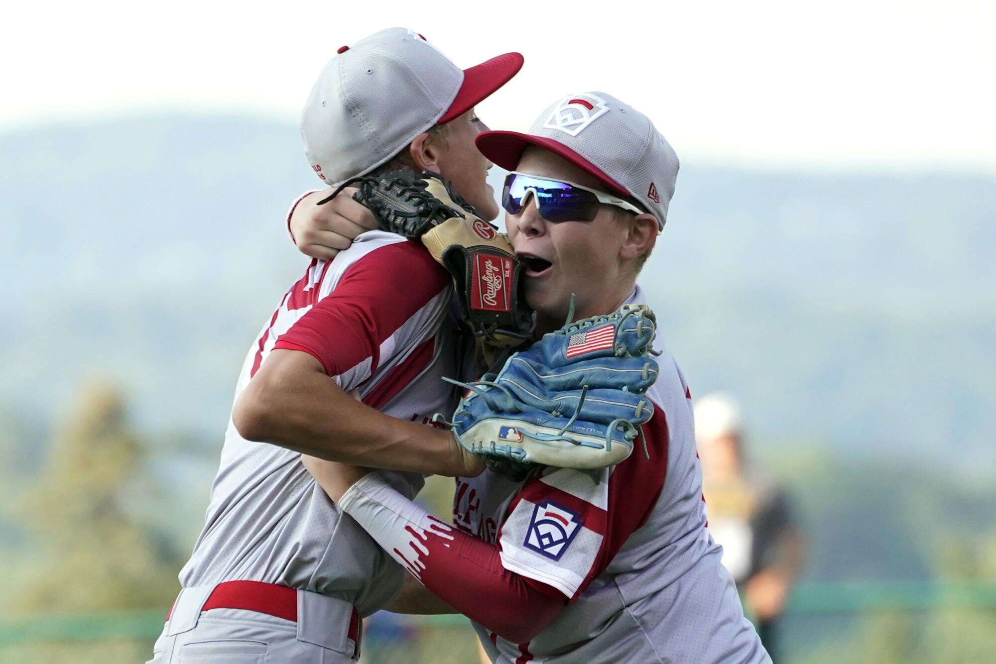 Sioux Falls, S.D. pitcher Gavin Weir, left, and teammate Noah Kuenzi celebrate the team's win over Torrance, Calif.