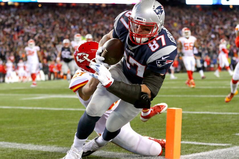 Patriots tight end Rob Gronkowski makes a touchdown catch against Chiefs defensive back Tyvon Branch in the third quarter Saturday.
