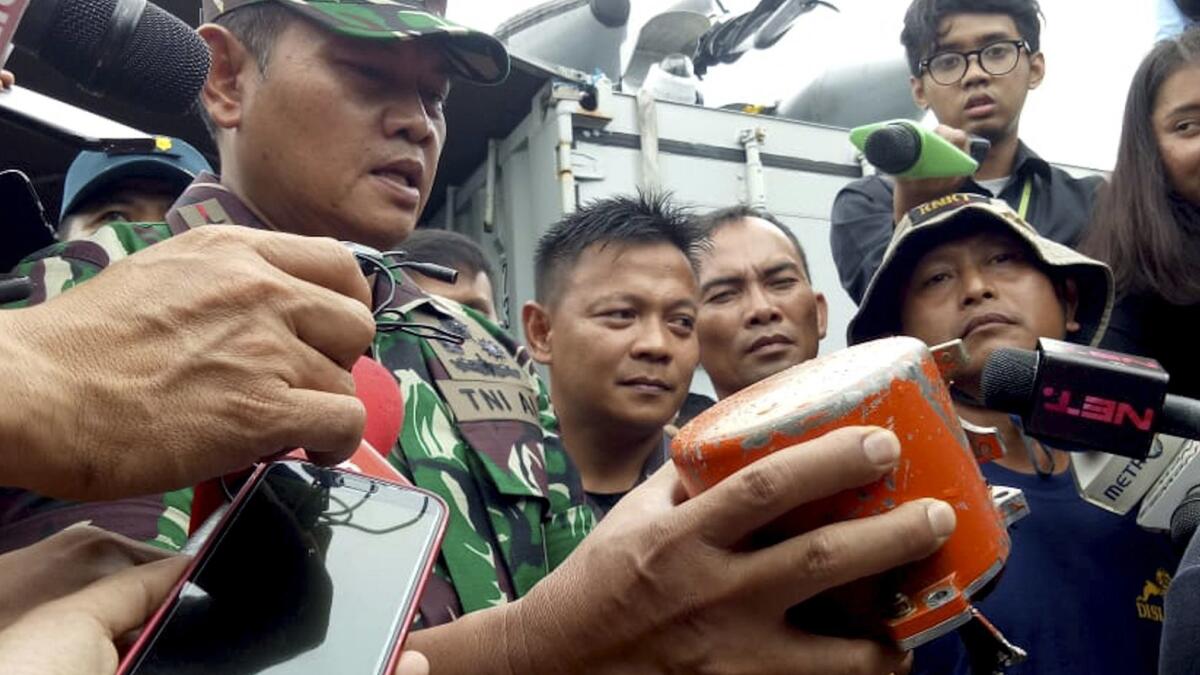 Indonesian navy Rear Adm. Yudo Margin shows the recovered cockpit voice recorder of Lion Air flight 610 during a news conference on Monday.