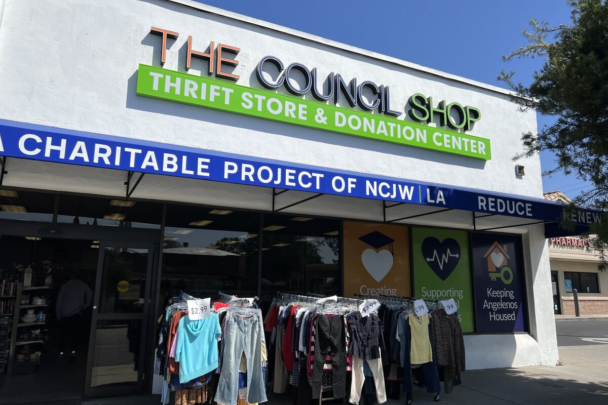 The Council Shop in Burbank with racks of clothes out front.