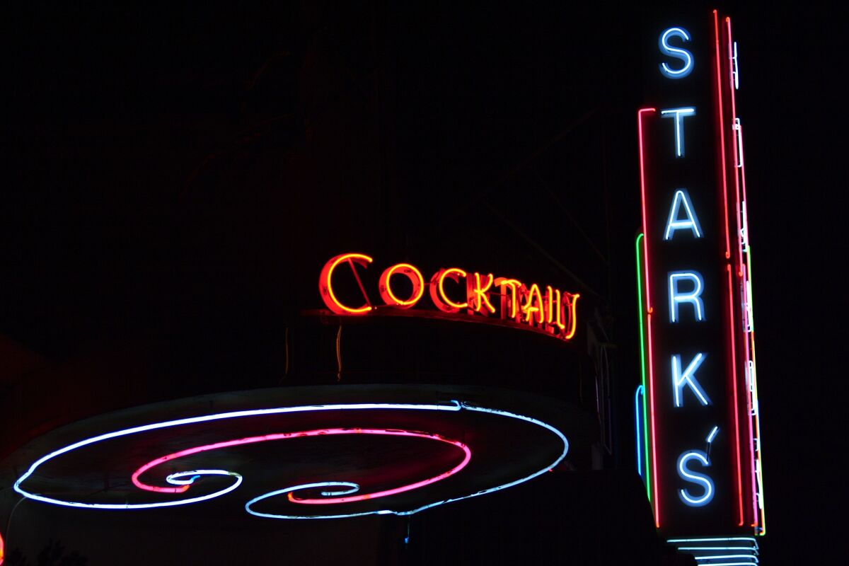 Neon signs say "cocktails" and "Stark's."