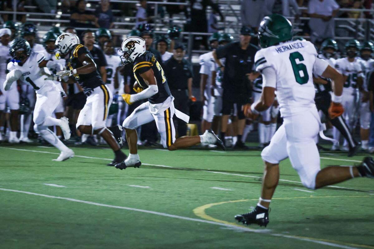 Newbury Park receiver Shane Rosenthal (21) runs down the field for a touchdown during a game vs. Pacifica.