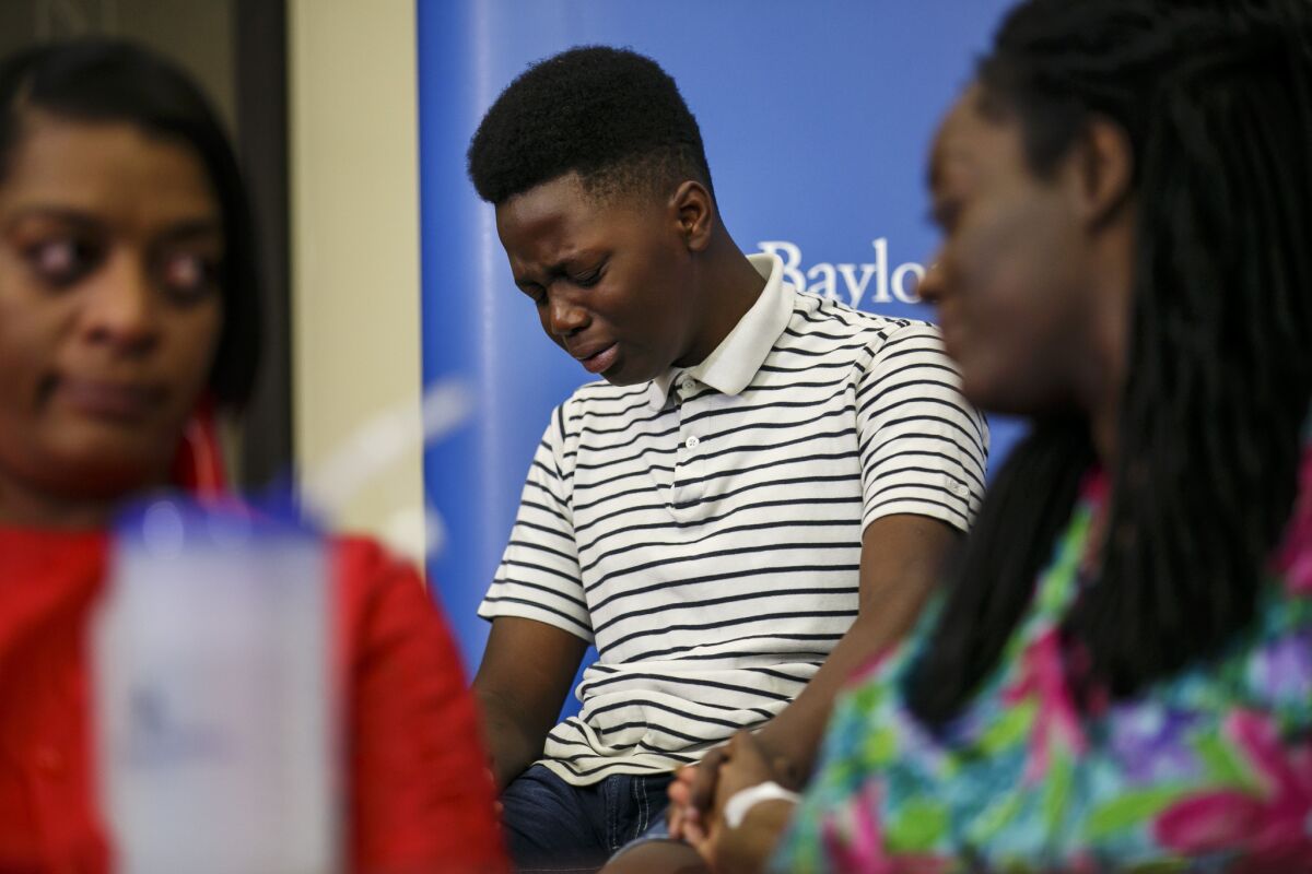 Jermar Taylor, 12, breaks down during a news conference July 10 in Dallas as he recalls Thursday's shooting, which left his mother injured.