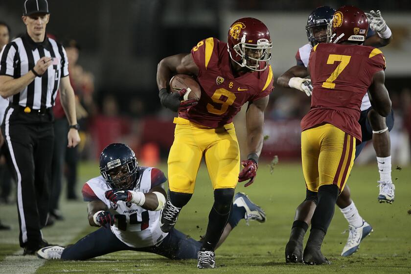 USC receiver JuJu Smith-Schuster sprints past Arizona defender Paul Magloire Jr. for a 72-yard touchdown on a long catch and run during the second quarter of Saturday's game.