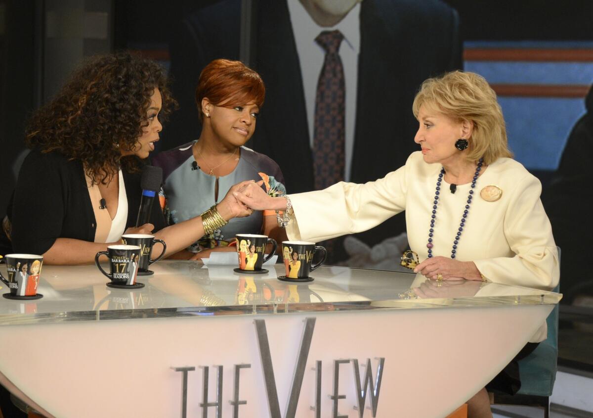 Oprah Winfrey, left, surprised Barbara Walters, right, on Walters' final episode of "The View."