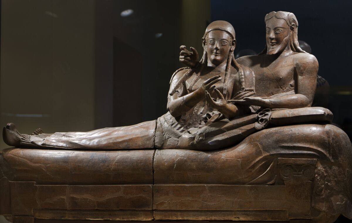 The terracotta Sarcophagus of the Spouses is displayed in Rome's National Etruscan Museum, Monday, Feb. 14, 2022. On Valentine Day museum's director, Valentino Nizzo unveiled a project to insulate the famous terracotta couple from the vibration coming from the intense traffic surrounding the museum that is endangering the fragile material with which the embracing couple is molded. (AP Photo/Domenico Stinellis)