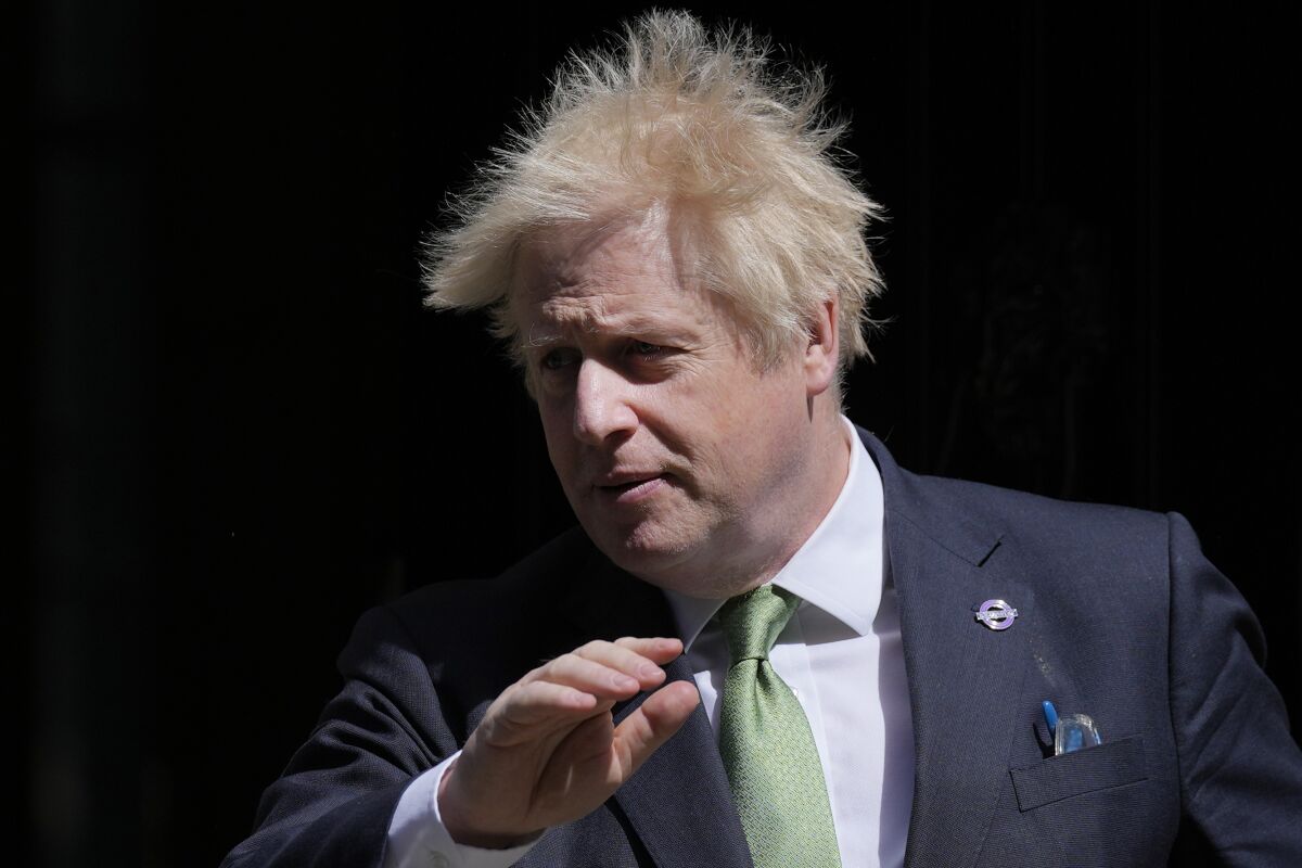 Britain's Prime Minister Boris Johnson leaves 10 Downing Street for the House of Commons for the weekly Prime Minister's Questions in London, Wednesday, May 18, 2022. (AP Photo/Alastair Grant)