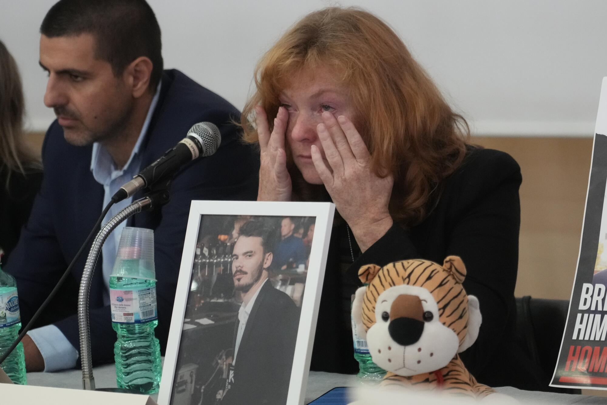 Woman whose son is being held hostage in Gaza wiping away tears