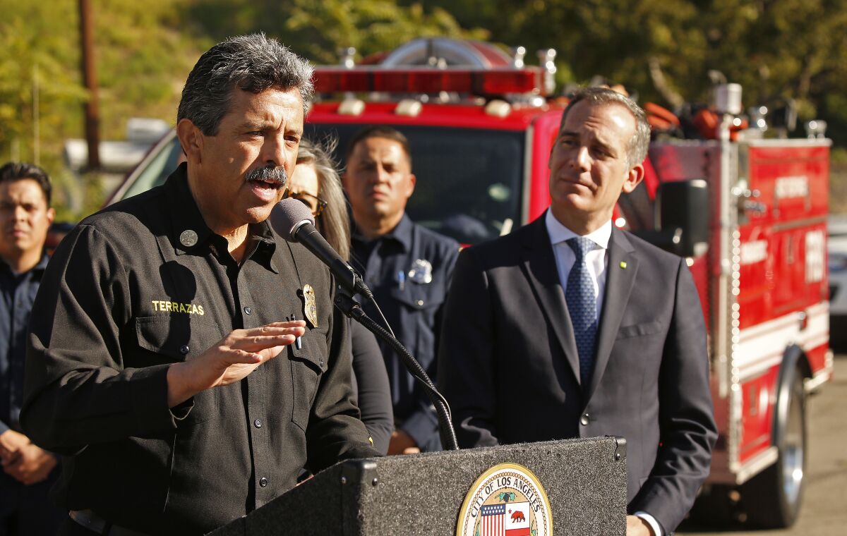 L.A. Fire Fire Department Chief Ralph Terrazas, left, speaks at a news conference with Mayor Eric Garcetti.