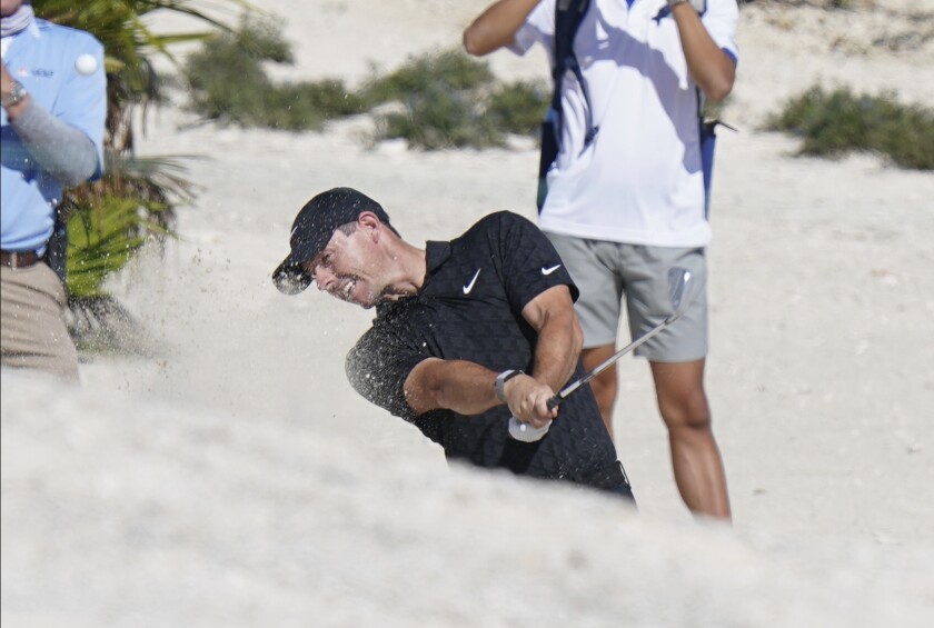 Rory McIlroy, of Northern Ireland, hits out of a bunker on the 5th hole during the first round of the Hero World Challenge PGA Tour at the Albany Golf Club, in New Providence, Bahamas, Thursday, Dec. 2, 2021.(AP Photo/Fernando Llano)