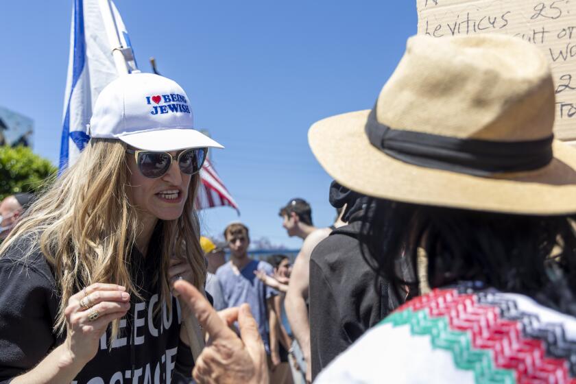 Los Angeles, CA - June 23: Pro-Israel protester argues with a Pro-Palestine protester near Adas Torah on 9040 block of West Pico Boulevard on Sunday, June 23, 2024 in Los Angeles, CA. (Zoe Cranfill / Los Angeles Times)