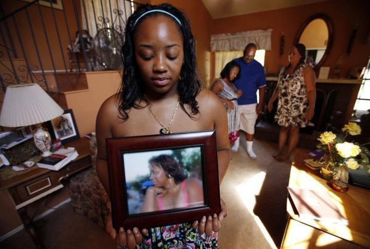 Khristina Henry holds a photo of her mother, Pamela Lark. Lark was killed in 2007 by Tyquan Knox, days before Khristina was scheduled to testify against Knox in a robbery case. On Thursday, Knox's then-girlfriend confessed to driving Knox to and from the shooting.