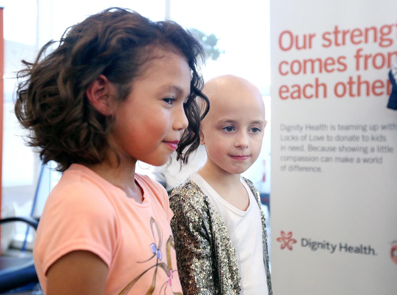 Aryanna Vidal, 9, of North Hollywood, smiles with Riley Sylvaria, 7, of Bristol for a post-donation photo at Dignity Health - Glendale Memorial Hospital for a hair donation event for Locks of Love on Thursday, November 8, 2018. Twelve people donated at least twelve inches of hair, three people had crewcuts removing nearly all of their hair, and three people brought in precut hair for a total of eighteen donations.