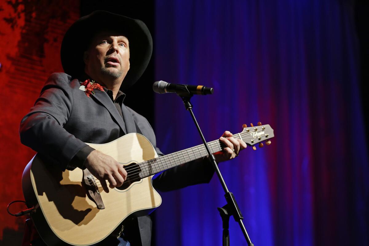 Garth Brooks, shown in a 2012 performance in Nashville, has written to the promoter of his concerts in Dublin, Ireland, saying he's still willing to play the canceled shows if government officials can clear the roadblocks.