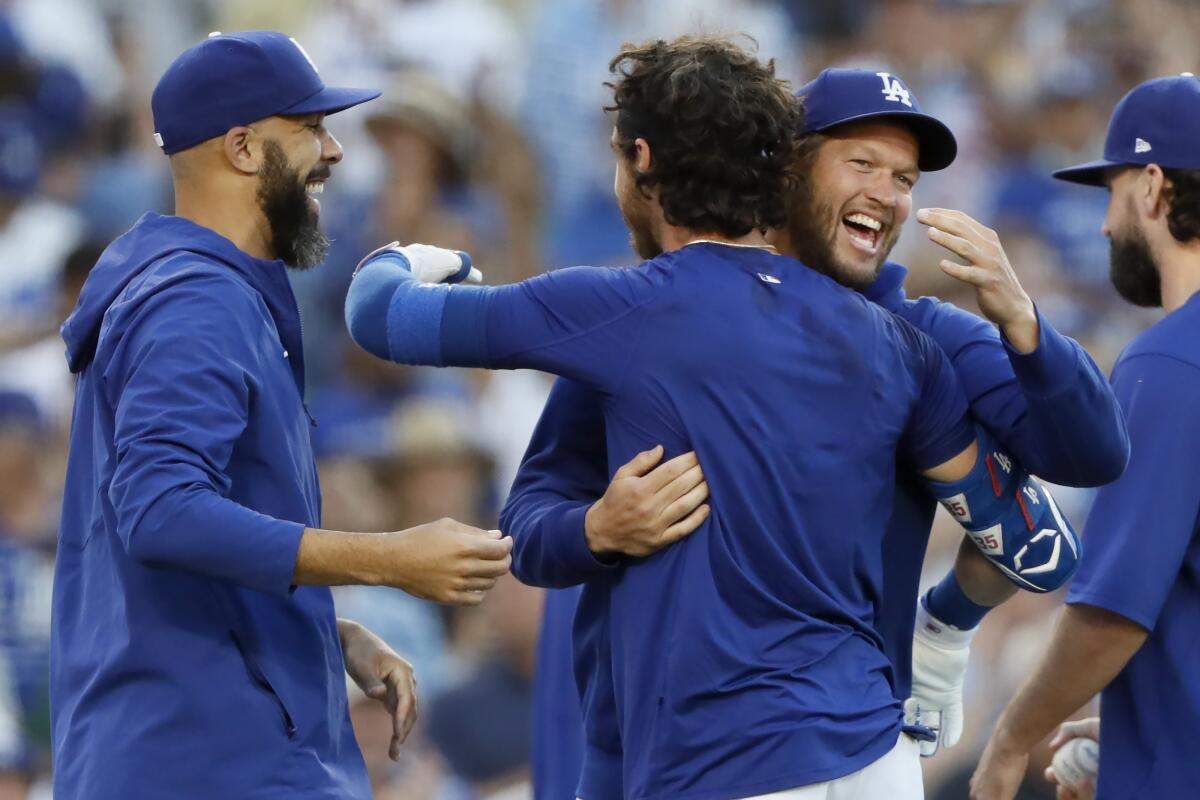 Cody Bellinger celebrates with Clayton Kershaw and David Price after hitting a walk-off home run.