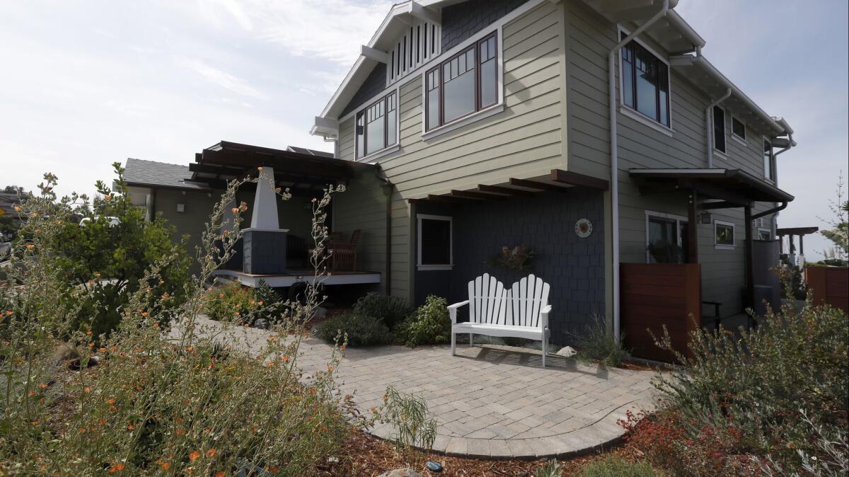 Rain gutters direct the moisture to underground dry wells dug 2 feet wide and 3 feet deep, filled with permeable landscaping fabric and rocks.