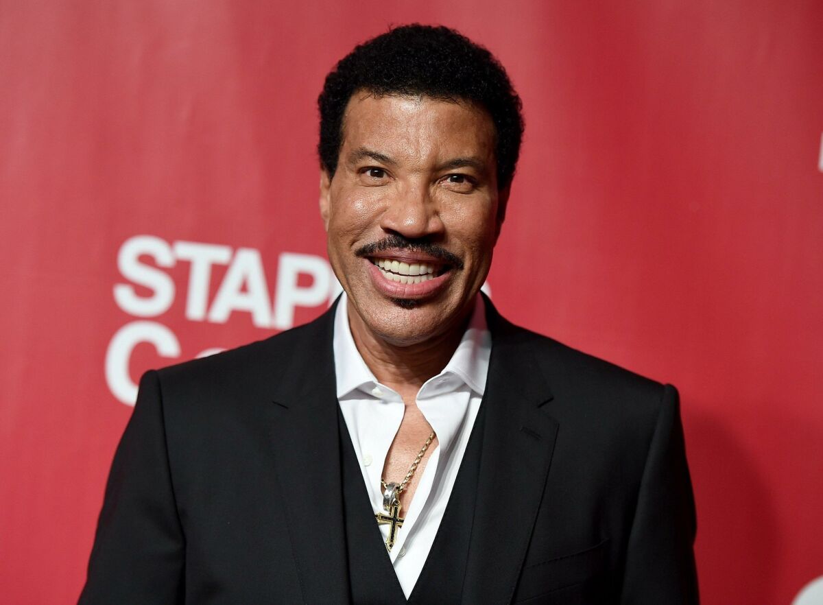 Lionel Richie arrives at the MusiCares Person of the Year tribute in his honor at the Los Angeles Convention Center on Saturday, Feb. 13, 2016. (Photo by Jordan Strauss/Invision/AP)
