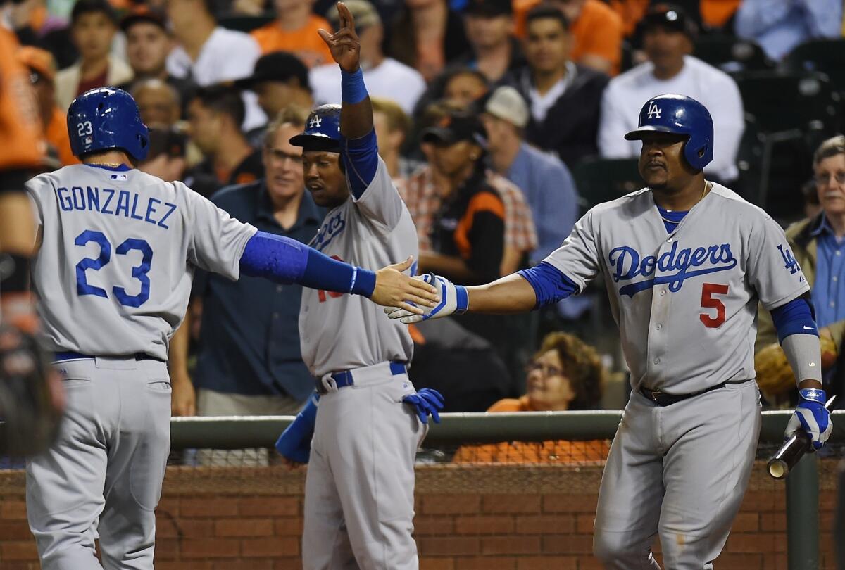 Adrian Gonzalez (23) and Hanley Ramirez, center, celebrate after scoring in the fifth inning against the Giants. The Dodgers defeated San Francisco, 8-1, at AT&T Park.