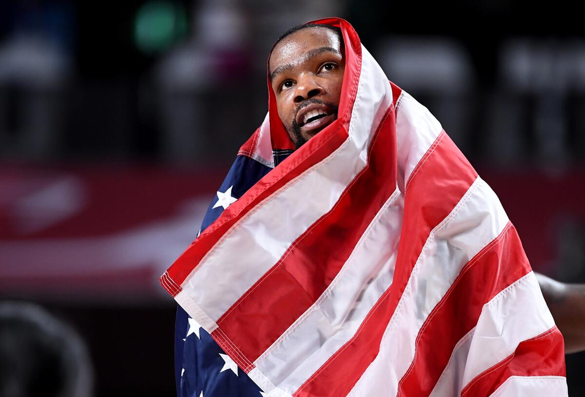 Kevin Durant celebrates while draped in the U.S. flag after Saturday's gold-medal win.