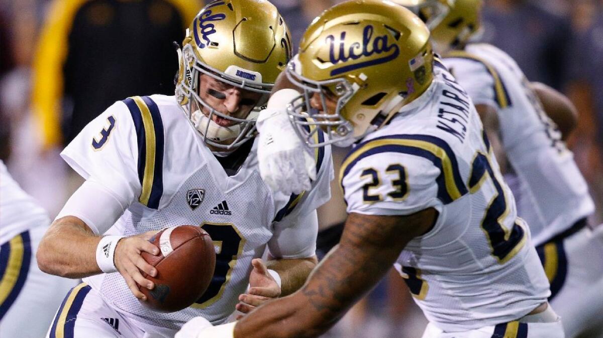 UCLA quarterback Josh Rosen fakes a handoff to running back Nate Starks during a game against Arizona State on Oct. 8.