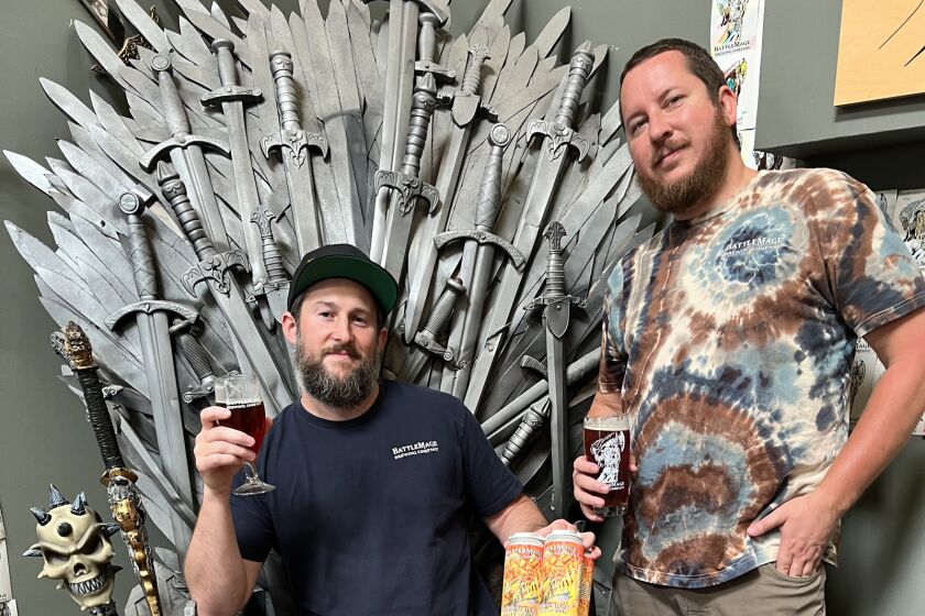 BattleMage Brewing co-founders Chris Barry, seated, and Ryan Sather, with their Summon Ifrit Hoppy Amber beer.