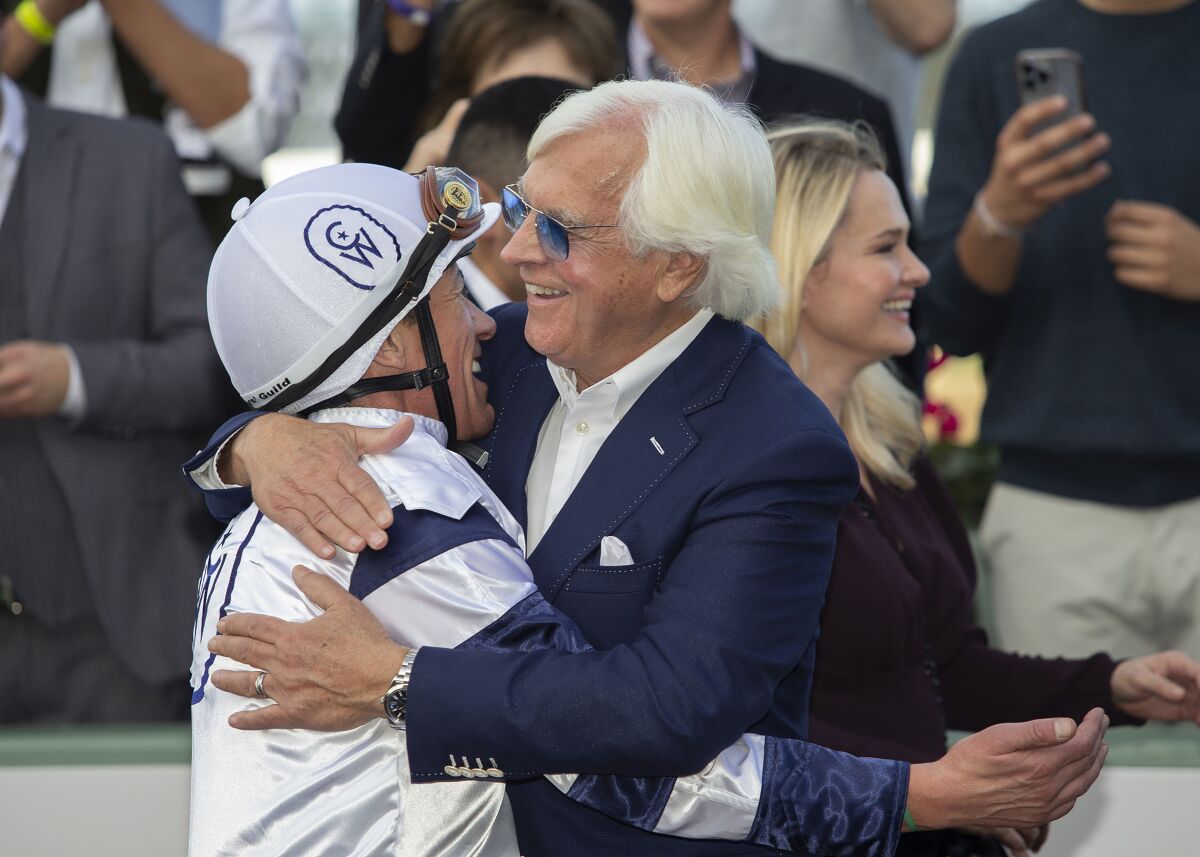 Country Grammar jockey Lanfranco Dettori and trainer Bob Baffert celebrate after their victory.