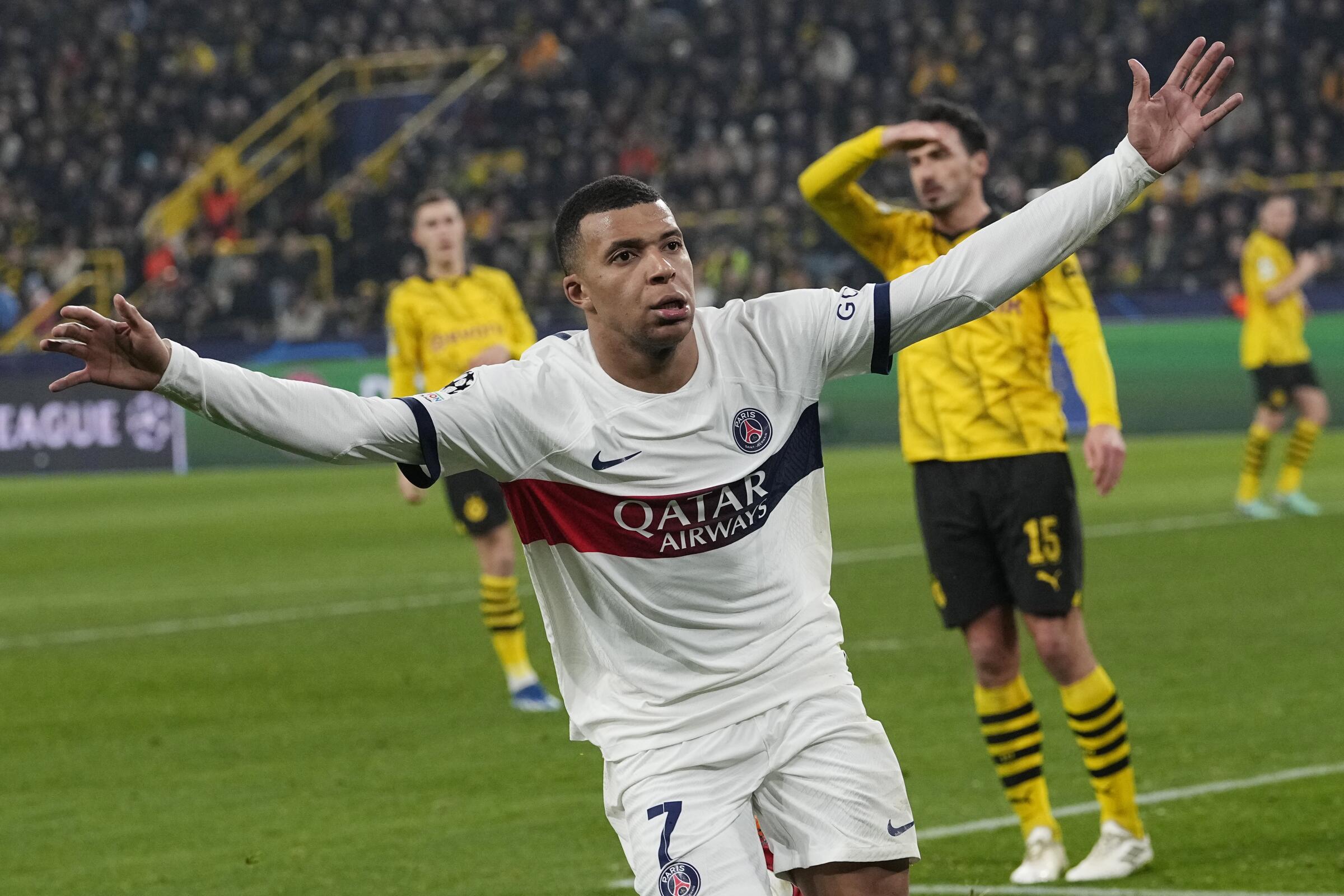 Kylian Mbappe holds out his arms after scoring a goal for Paris Saint-Germain in Champions League play.