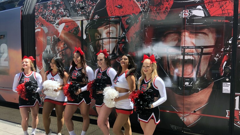 San Diego State cheerleaders helped announce new San Diego trolley wraps that feature SDSU football players.