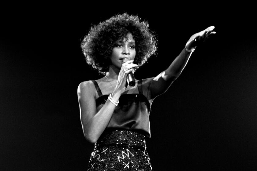 Whitney Houston performing on stage