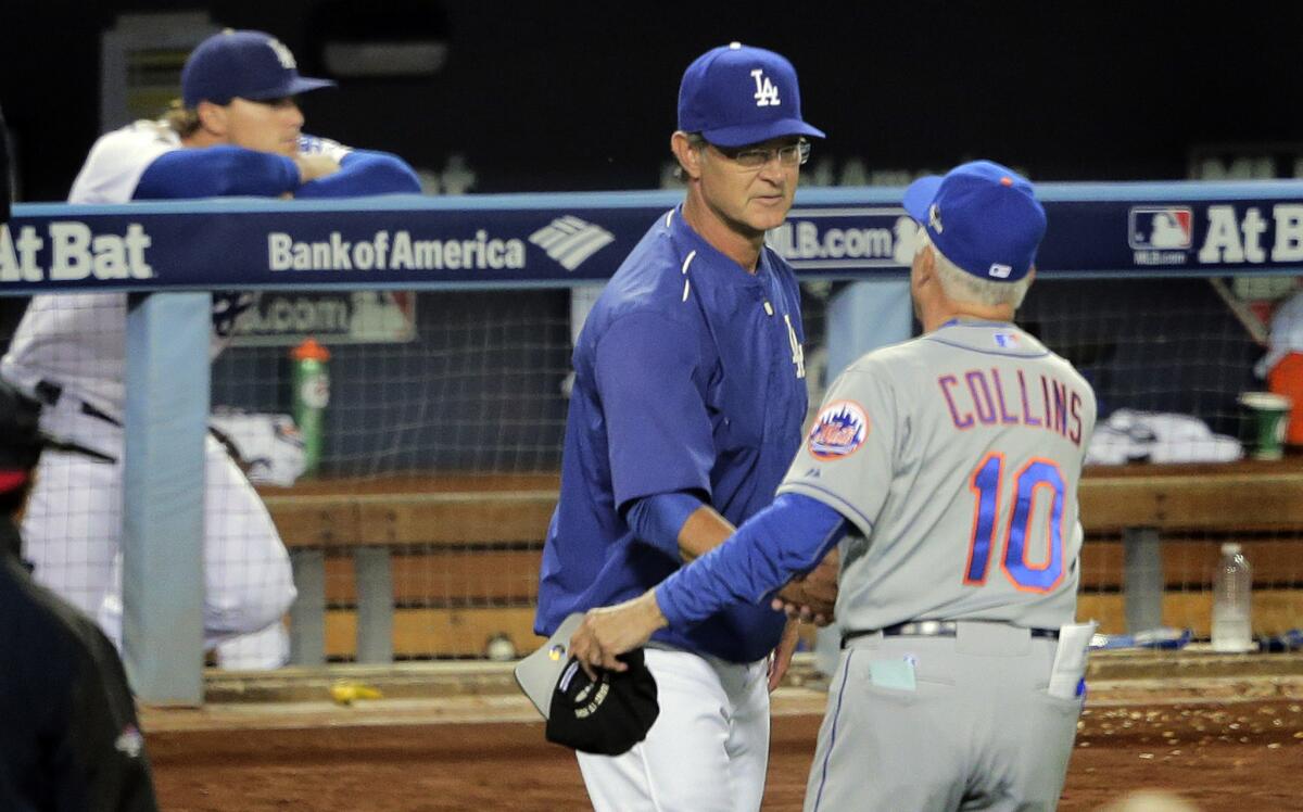 Manager Don Mattingly congratulates Mets Manager Terry Collins after the Dodgers were eliminated from the playoffs Thursday night.