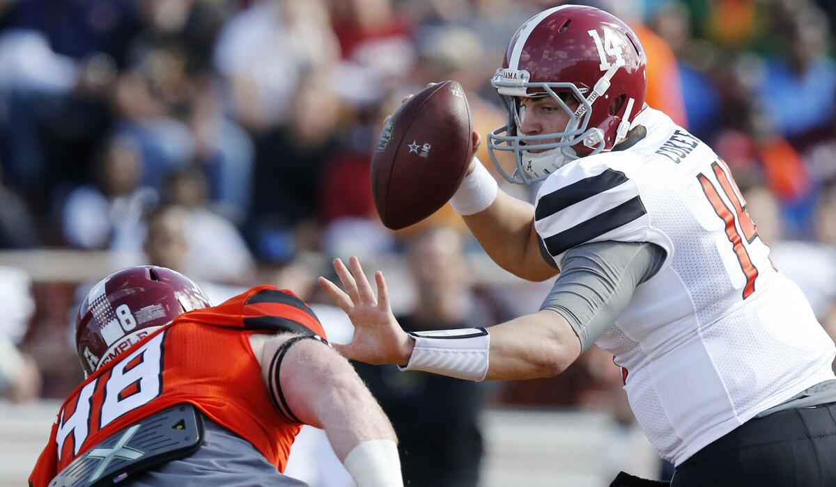 South Team quarterback Jake Coker, right, of Alabama, looks to avoid North Team linebacker Tyler Matakevich, of Temple, during the first half of the Senior Bowl on Saturday.