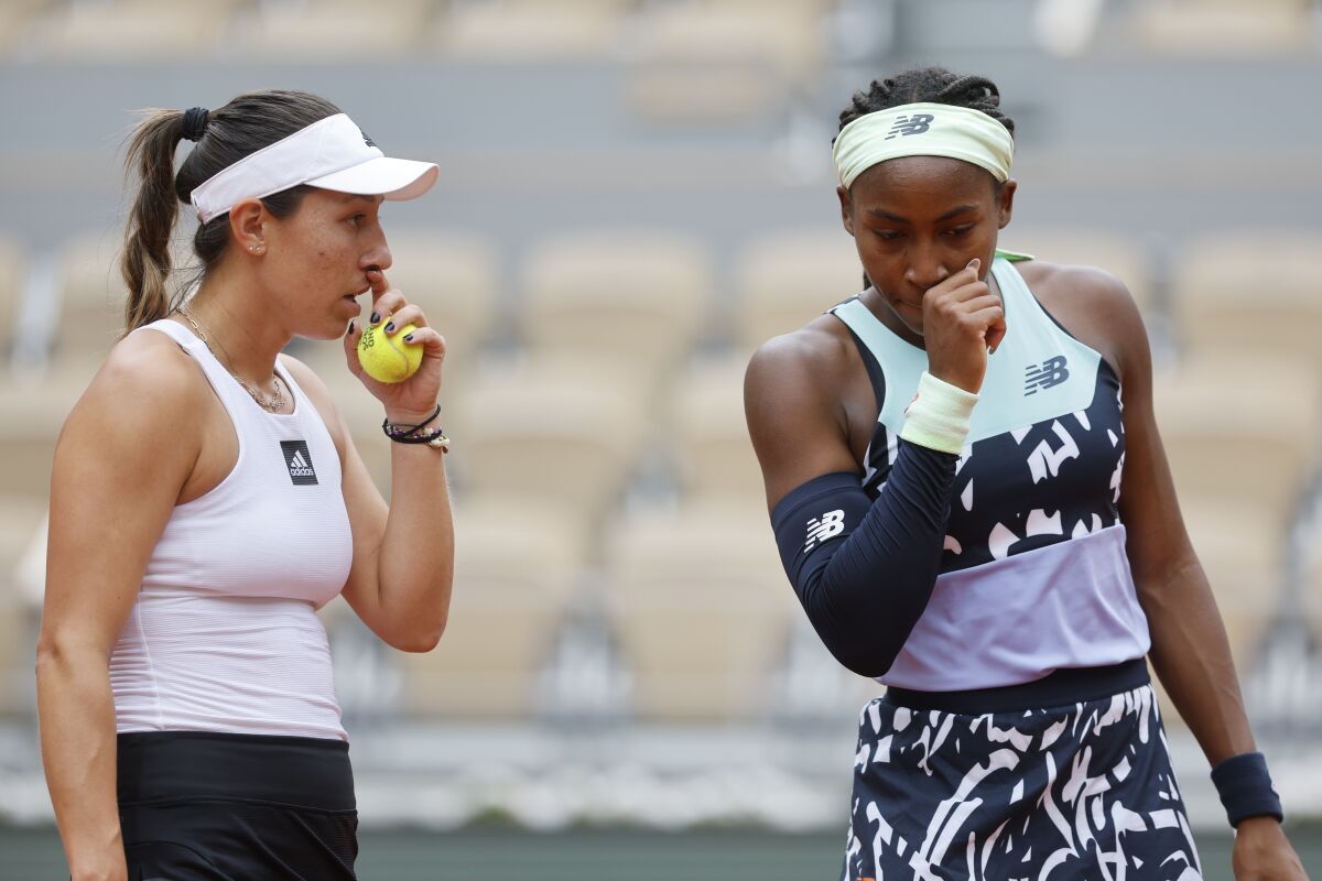 Coco Gauff of the U.S., right, and Jessica Pegula of the U.S. talk as they play France's Caroline Garcia and France's Kristina Mladenovic during their women doubles final match of the French Open tennis tournament at the Roland Garros stadium Sunday, June 5, 2022 in Paris. (AP Photo/Jean-Francois Badias)