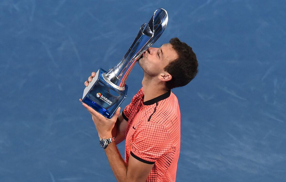 Grigor Dimitrov kisses his trophy after defeating Kei Nishikori in their final at the Brisbane International on Jan. 8.